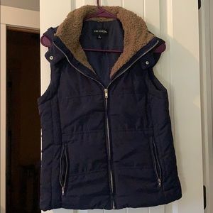 Never worn dark blue vest with brown fuzzy trim